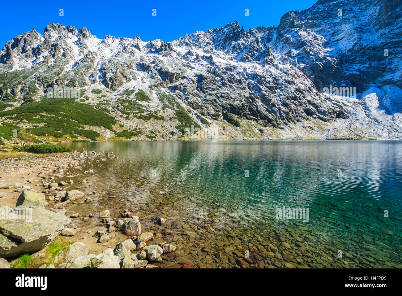 Czarny Staw alpine lake in autumn colours, High Tatra Mountains, Poland Stock Photo