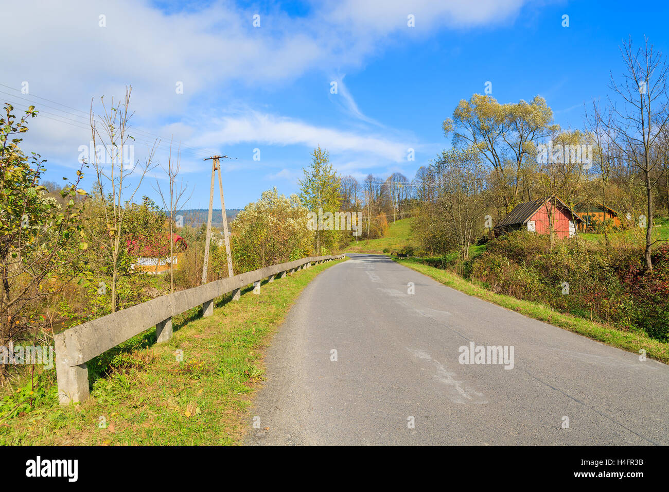 Countryside road on sunny autumn day, Beskid Niski Mountains, Poland Stock Photo