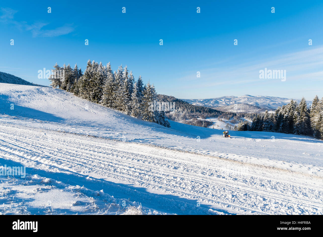 Winter road on sunny day in Beskid Sadecki Mountains, Poland Stock Photo