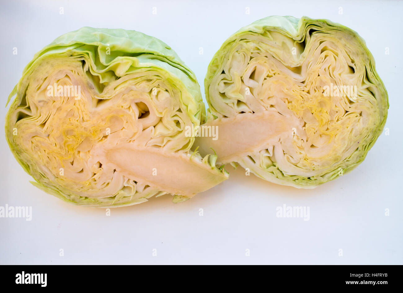 A whole green cabbage cut in half to use in your kitchen, food inspired Stock Photo