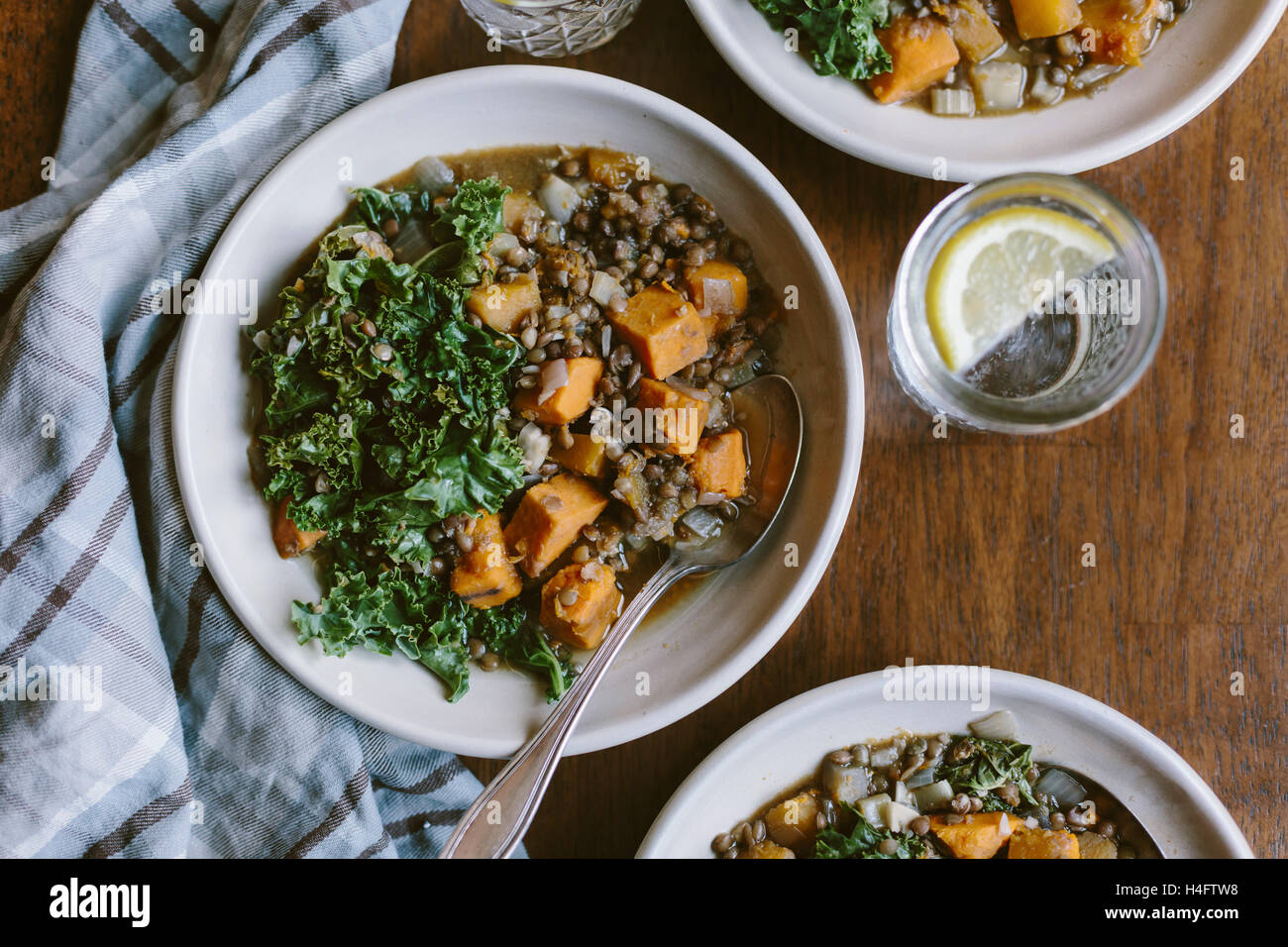 A bowl of Slow Cooked Butternut Squash Lentil Stew is photographed from the top view. Stock Photo