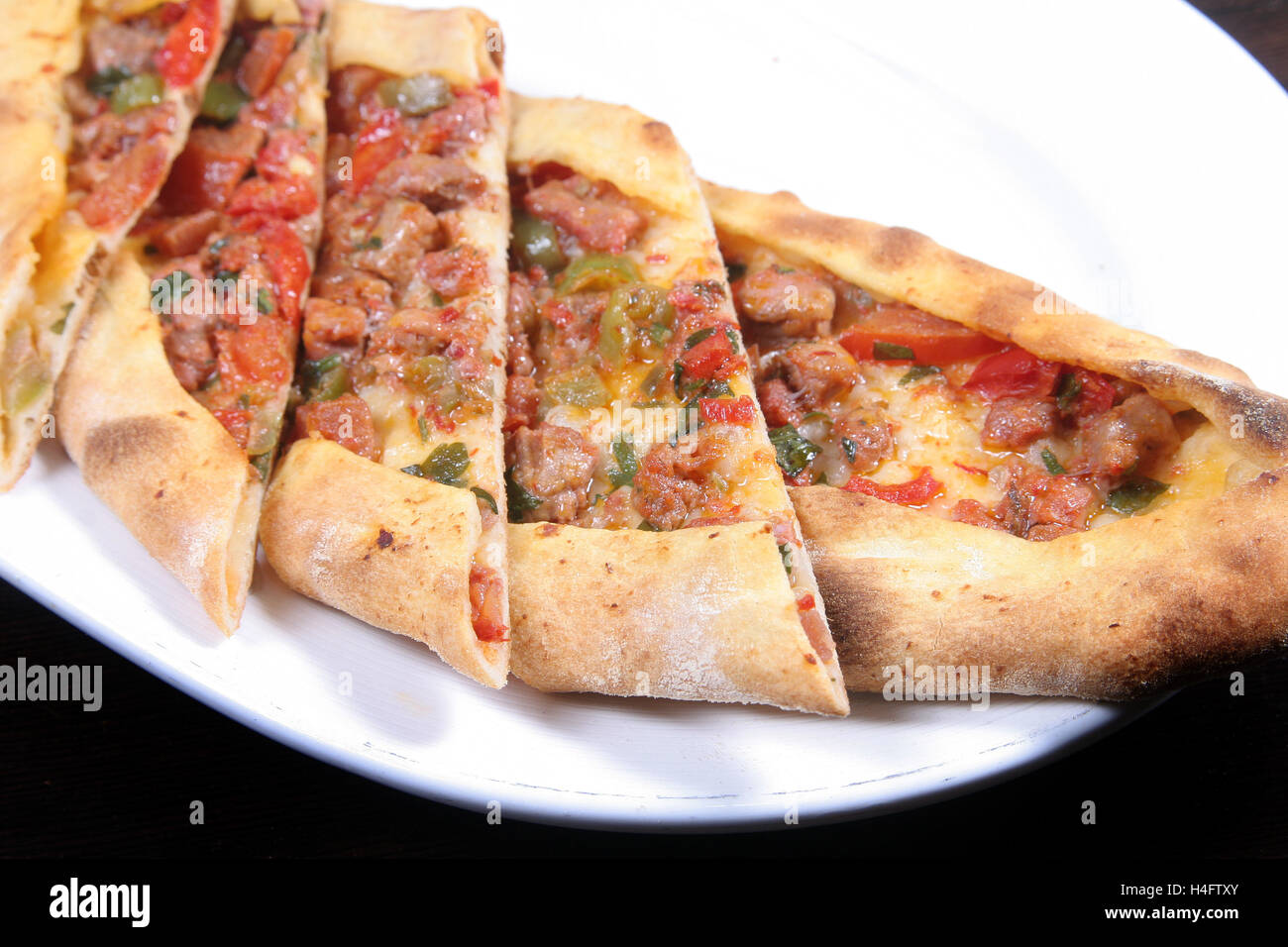 Turkish pizza (pide) with lamb cubes Stock Photo