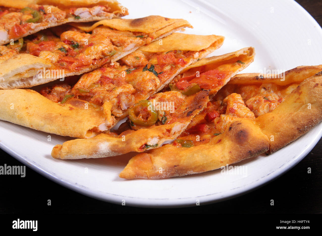 Turkish pizza (pide) with chicken cubes Stock Photo