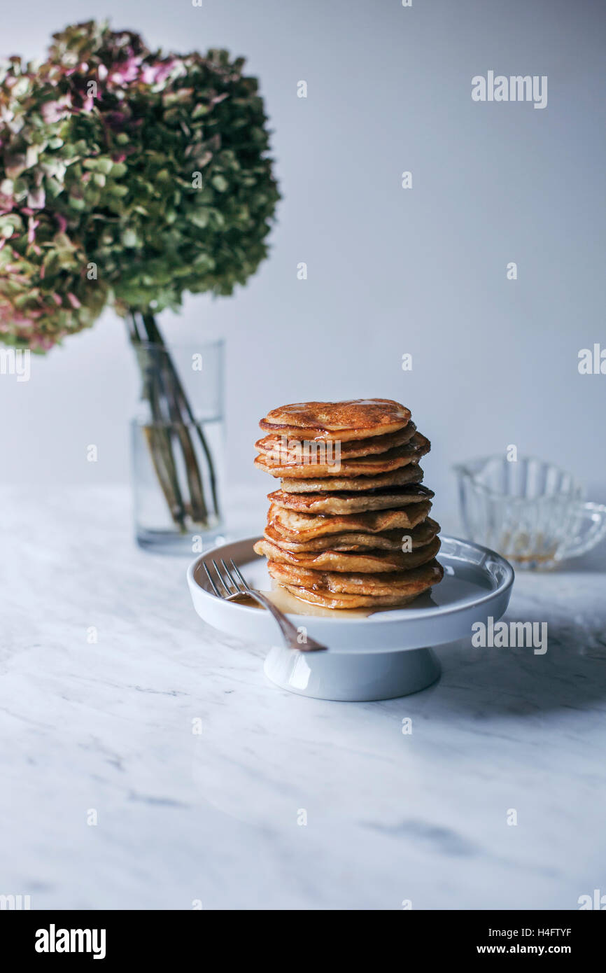 Stack of vegan banana pancakes stack drizzled with maple syrup Stock Photo