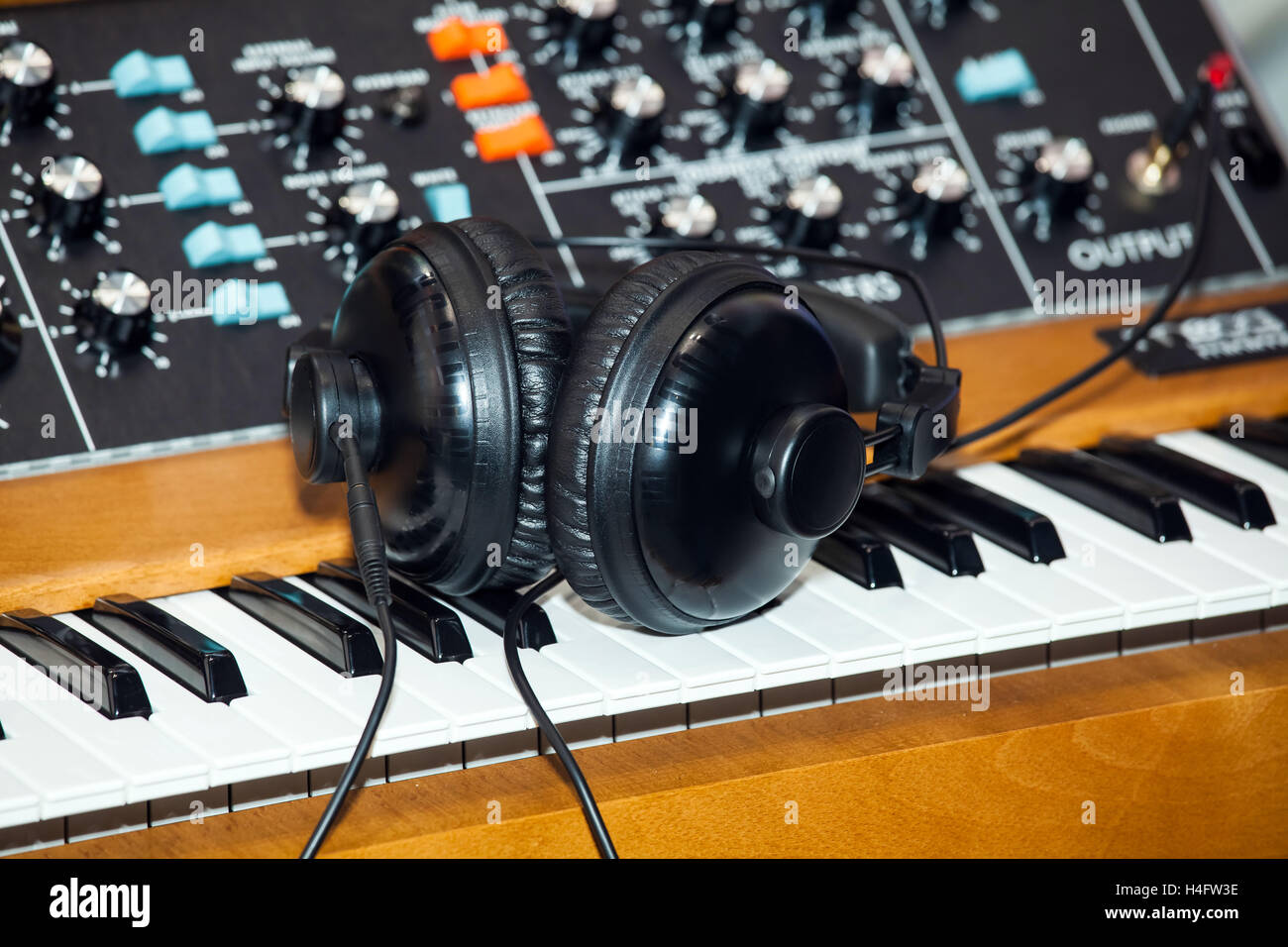 Black headphones on the keyboard piano Stock Photo Alamy