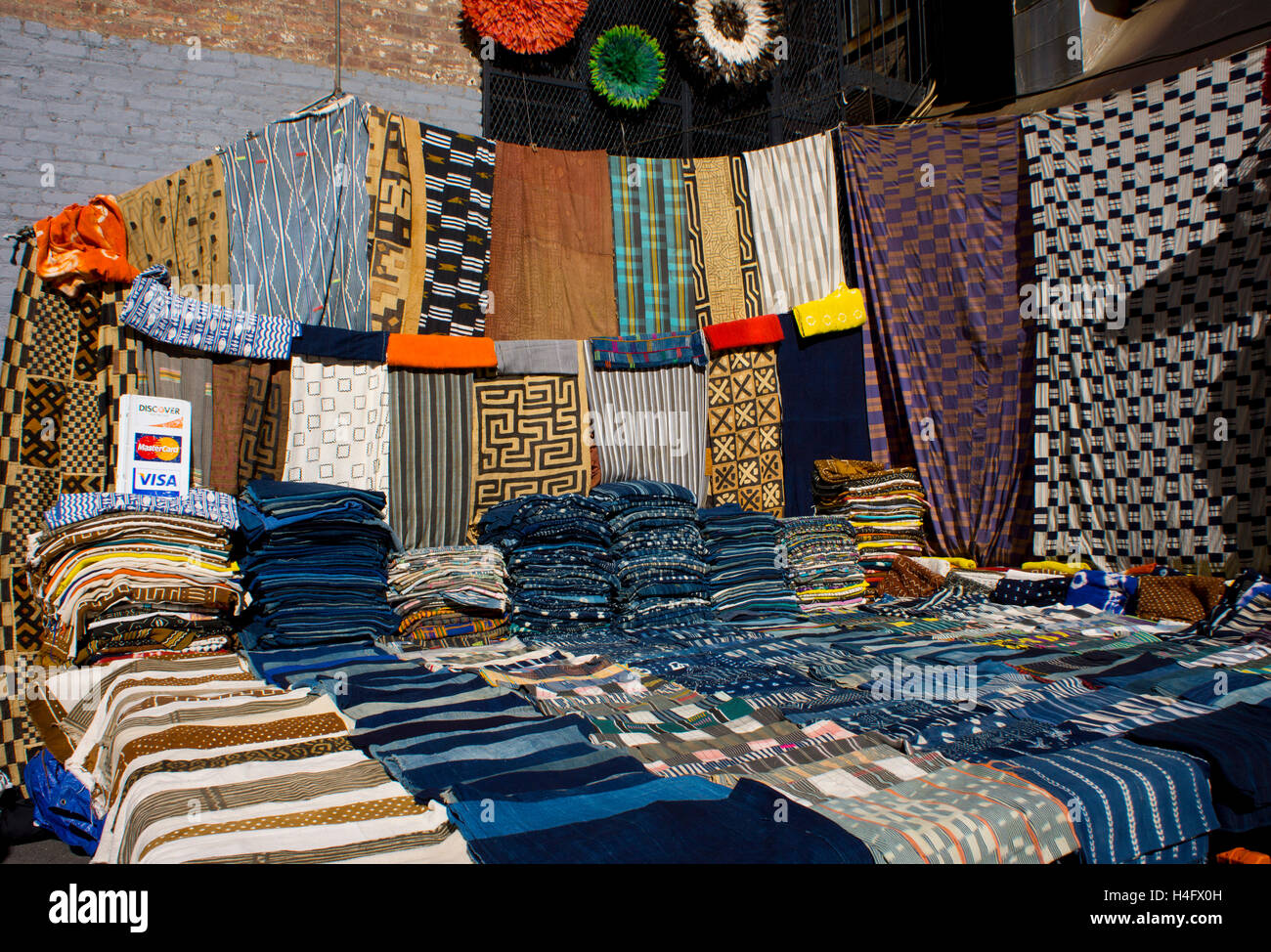 Display of ethnic African fabrics in the Chelsea flea market.  Manhattan, New York. Stock Photo