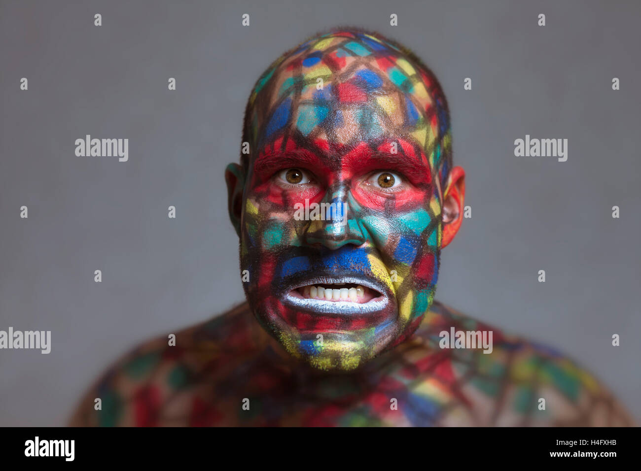 Furious villain portrait, colorful face art with tilt shift and motion blur effect. Stock Photo