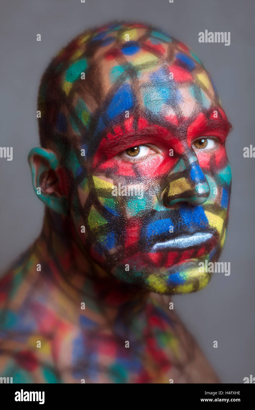 Serious villain portrait, colorful face art with tilt shift and motion blur effect. Stock Photo