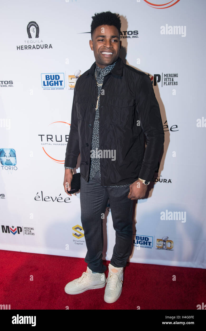 Michael Crabtree poses for a photo at the Glazer Palooza + Suits