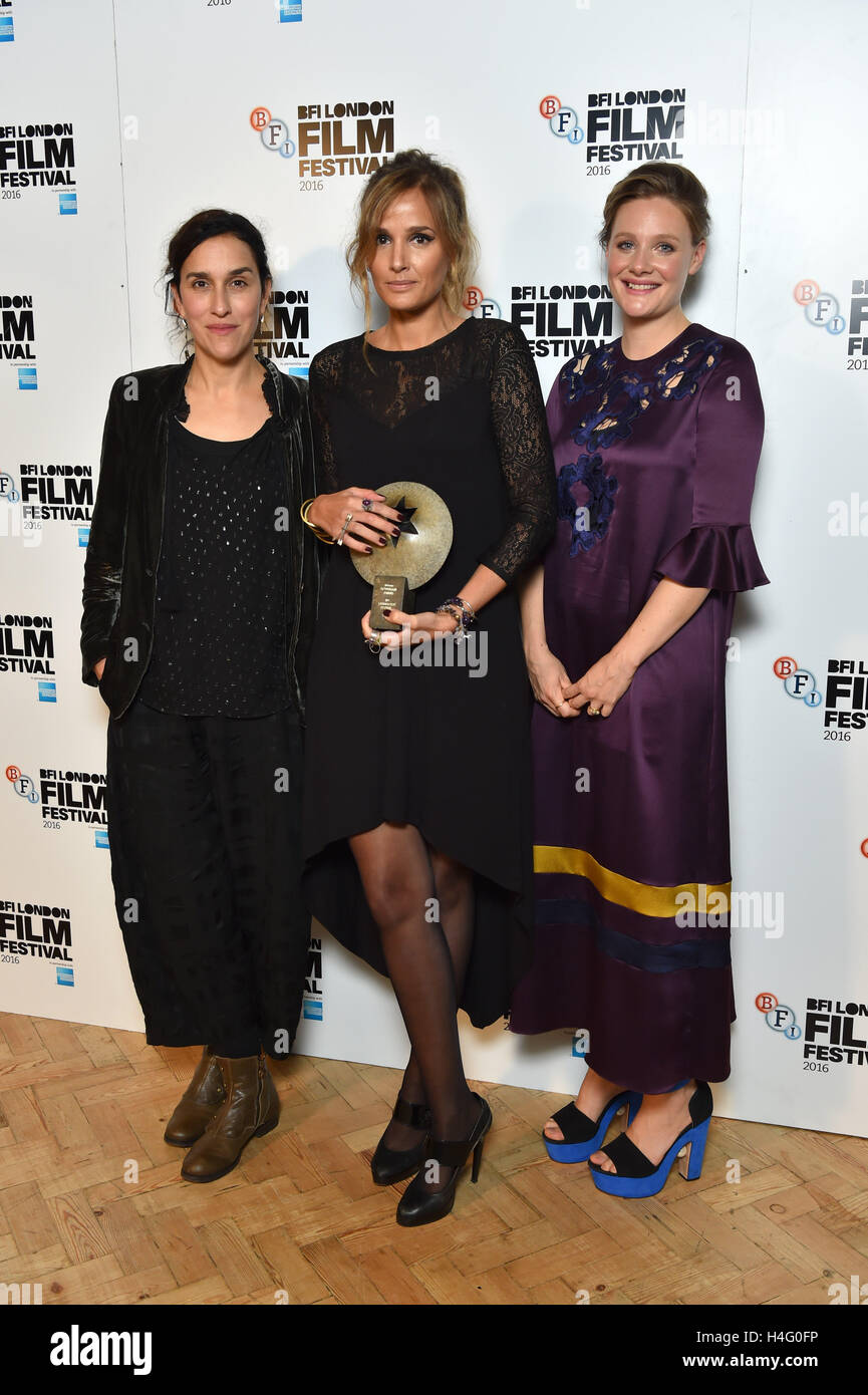 Director Julia Ducournau (centre), winner of the First Feature Sutherland award, with jury president Sarah Gavron (left) and presenter Romola Garai (right) pictured in the press room at the London Film Festival Awards, held at Banqueting House in London. Stock Photo