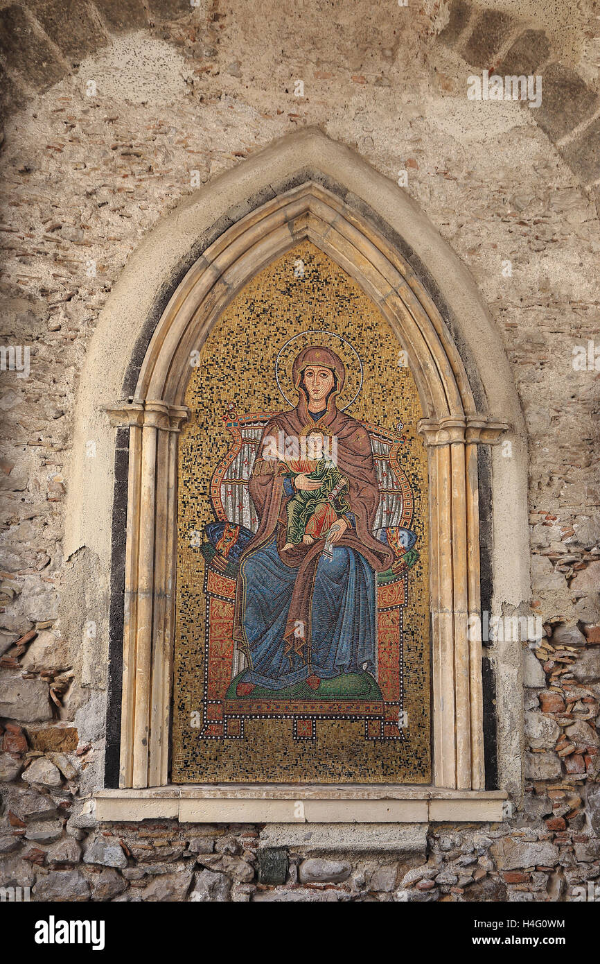 Mosaic of Mary and Jesus on wall of Torre dell’ Orologio tower of Taormina town, Sicily, Italy Stock Photo