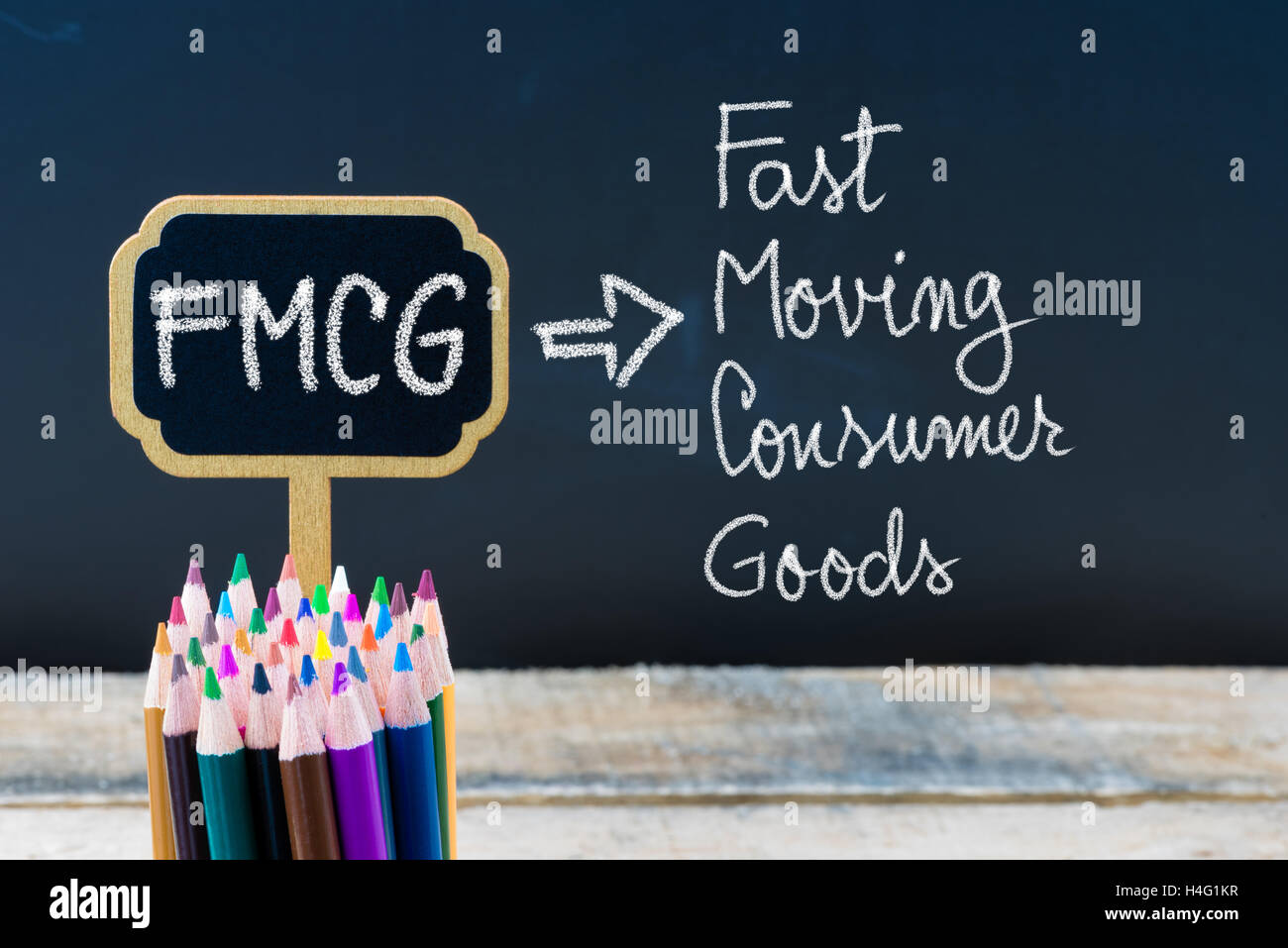 Business Acronym FMCG Fast Moving Consumer Goods written with chalk on  wooden mini blackboard labels and chalkboard background Stock Photo - Alamy