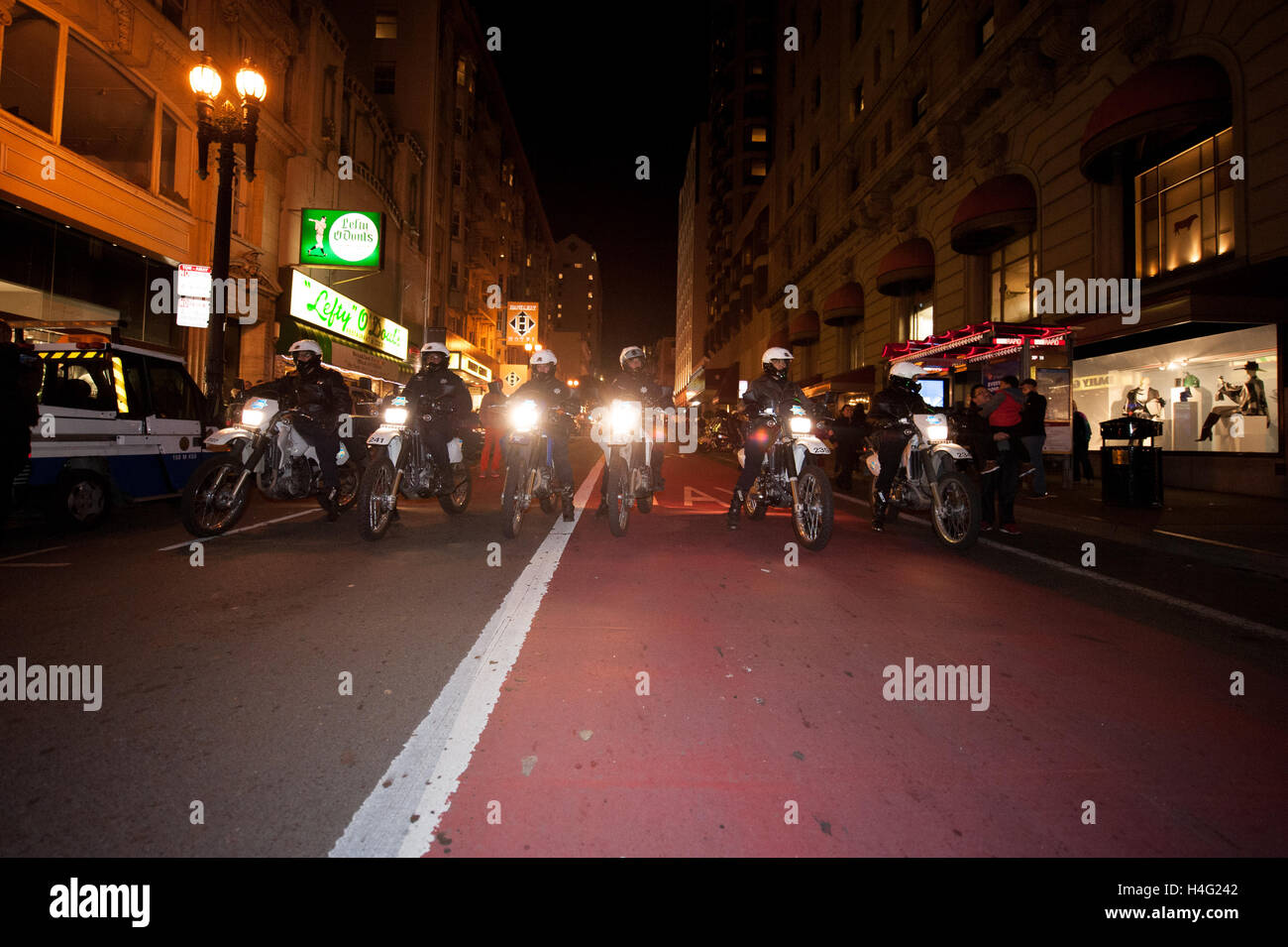 A line of San Francisco Police officers on motorcylces block Geary