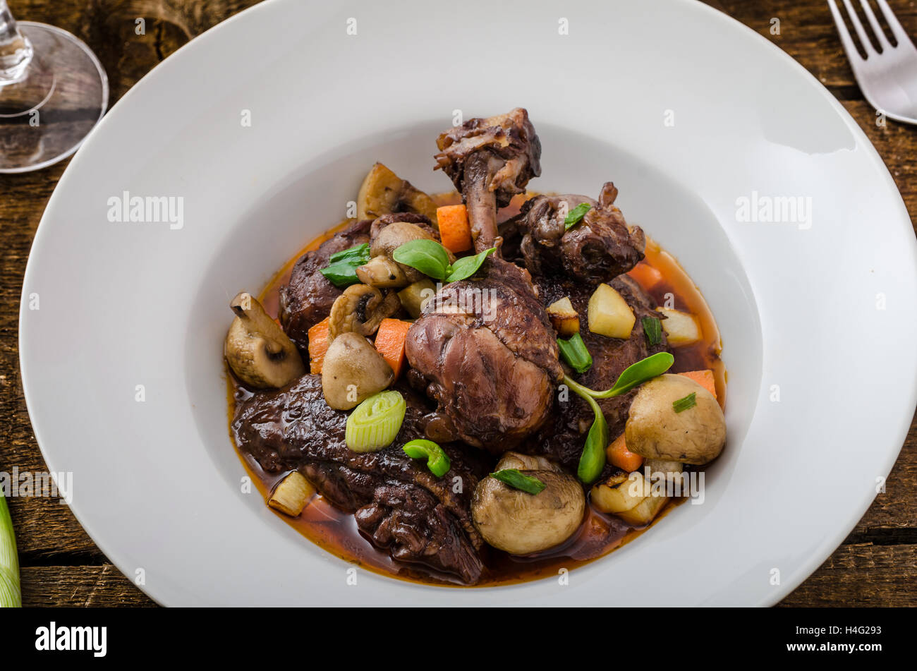 Chicken in red wine with vegetable and baked mushrooms Stock Photo