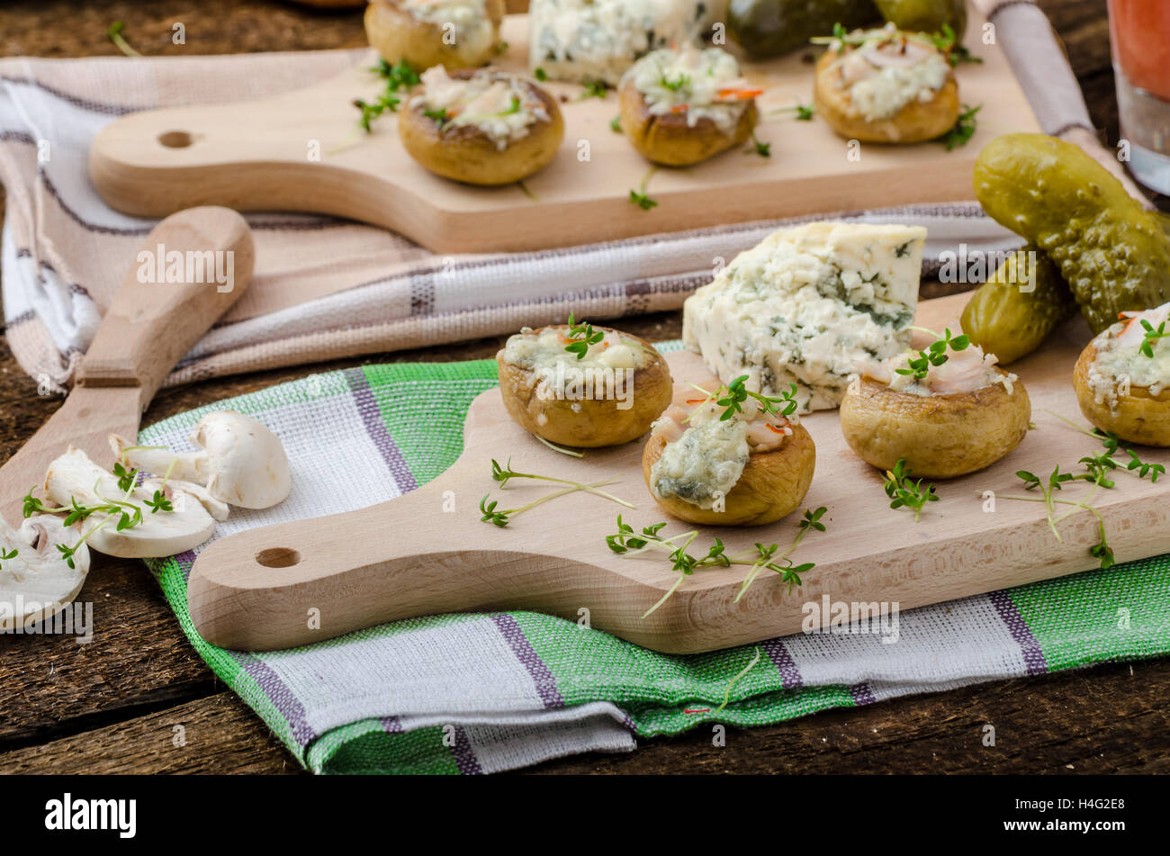 Mushrooms stuffed with blue cheese, microgreens on top, simple