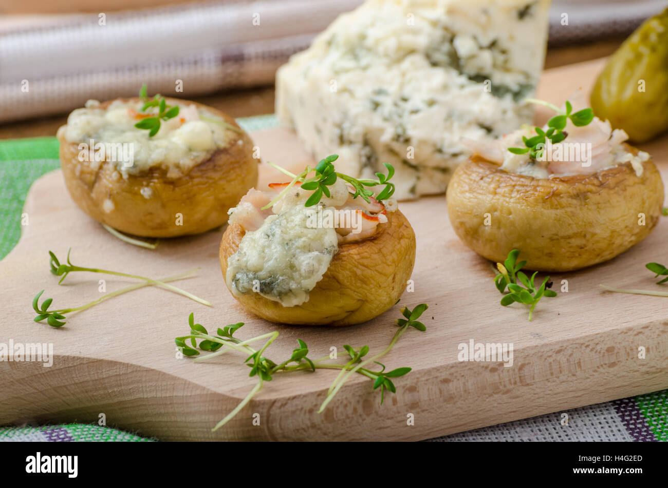 Mushrooms stuffed with blue cheese, microgreens on top, simple