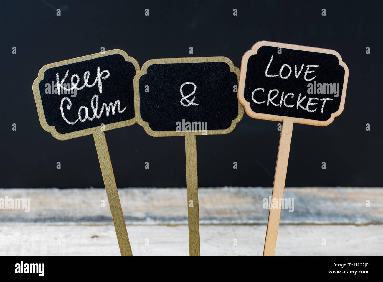 Keep Calm and Love Cricket message written with chalk on mini blackboard labels Stock Photo