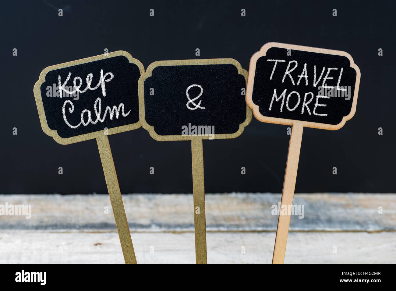 Keep Calm and Travel More message written with chalk on mini blackboard labels Stock Photo