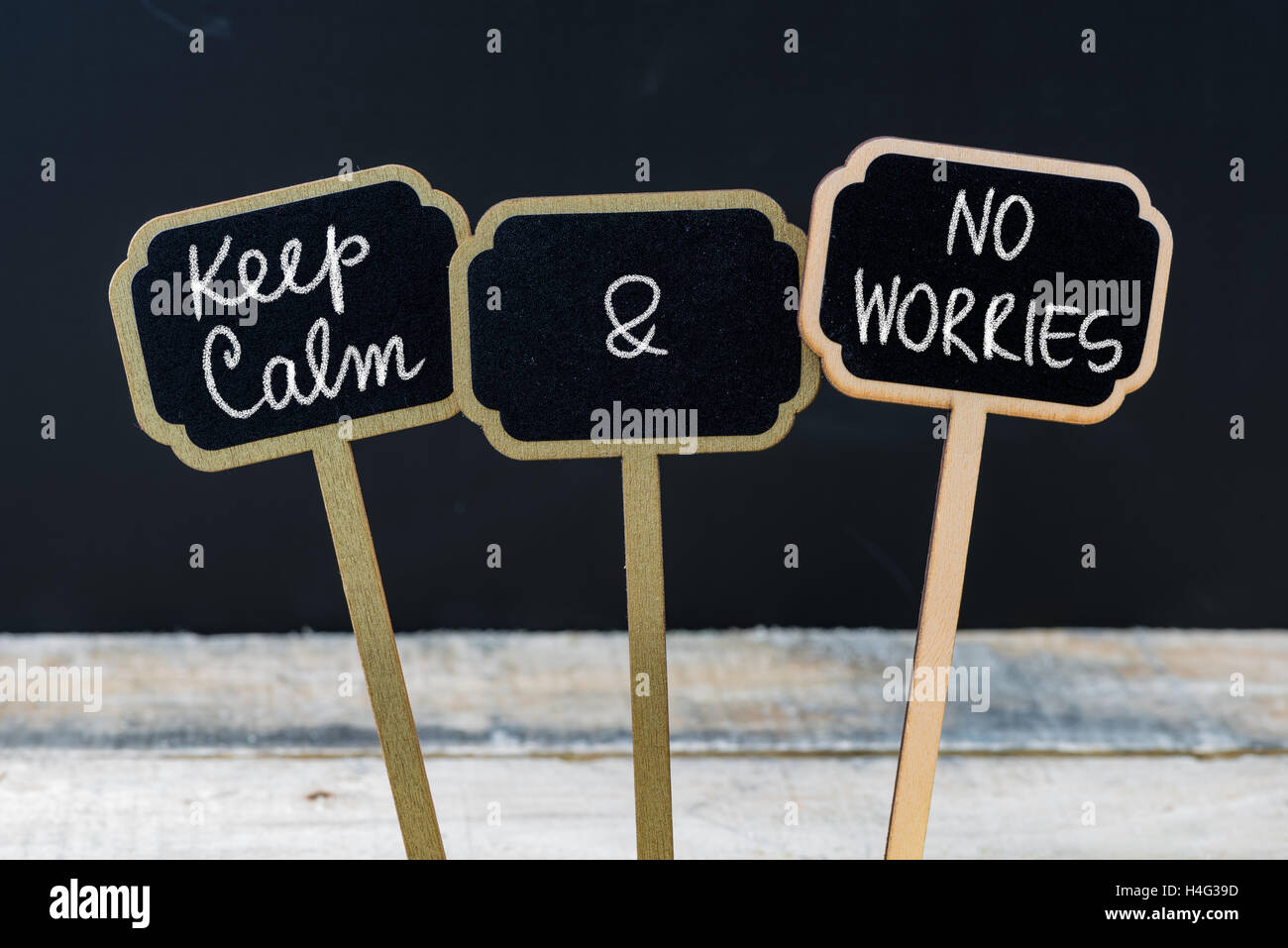 Keep Calm and No Worries message written with chalk on mini blackboard labels Stock Photo