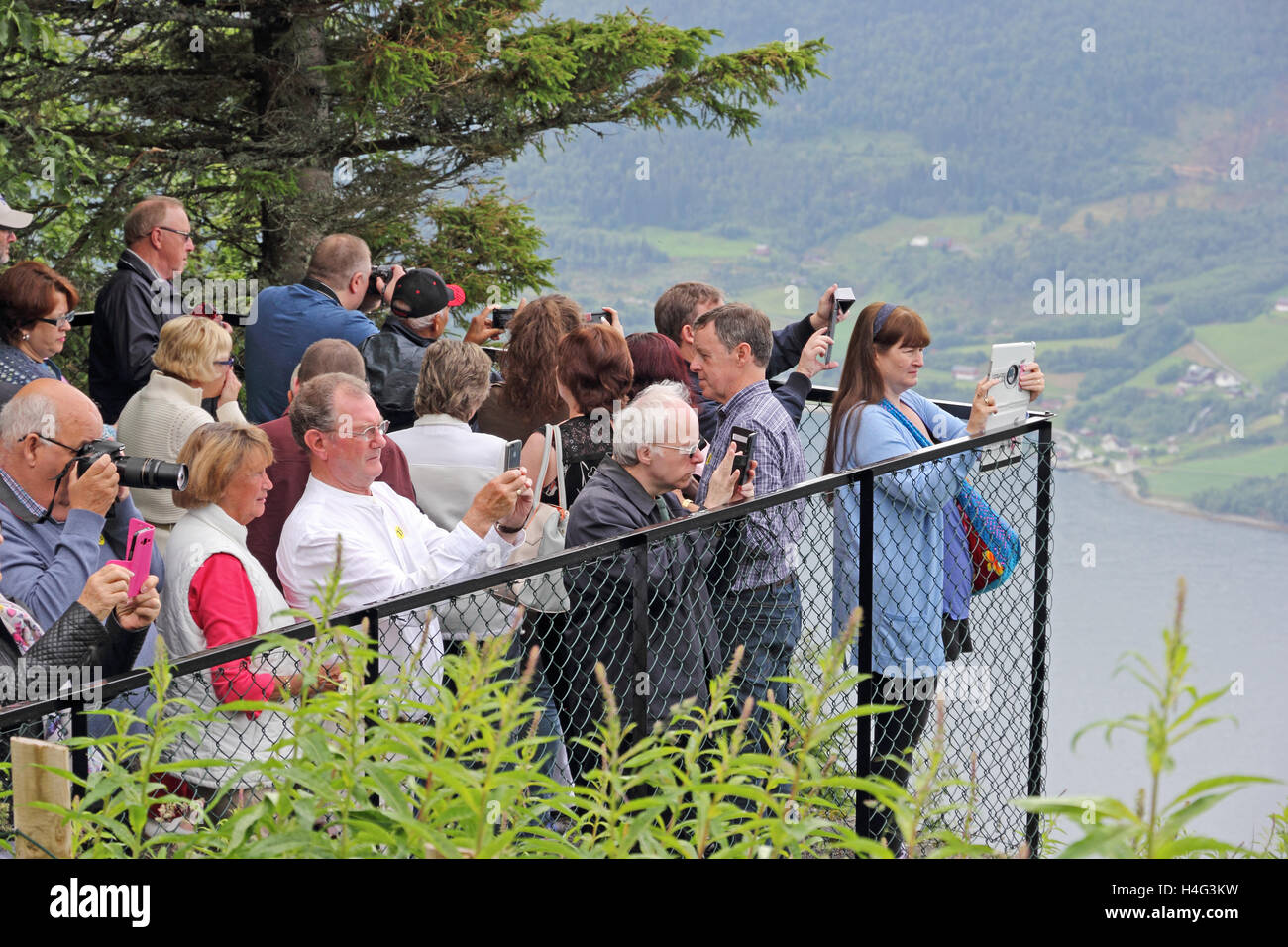 Tourists at high viewing point looking out over Nordfjorden near Olden, Norway Stock Photo