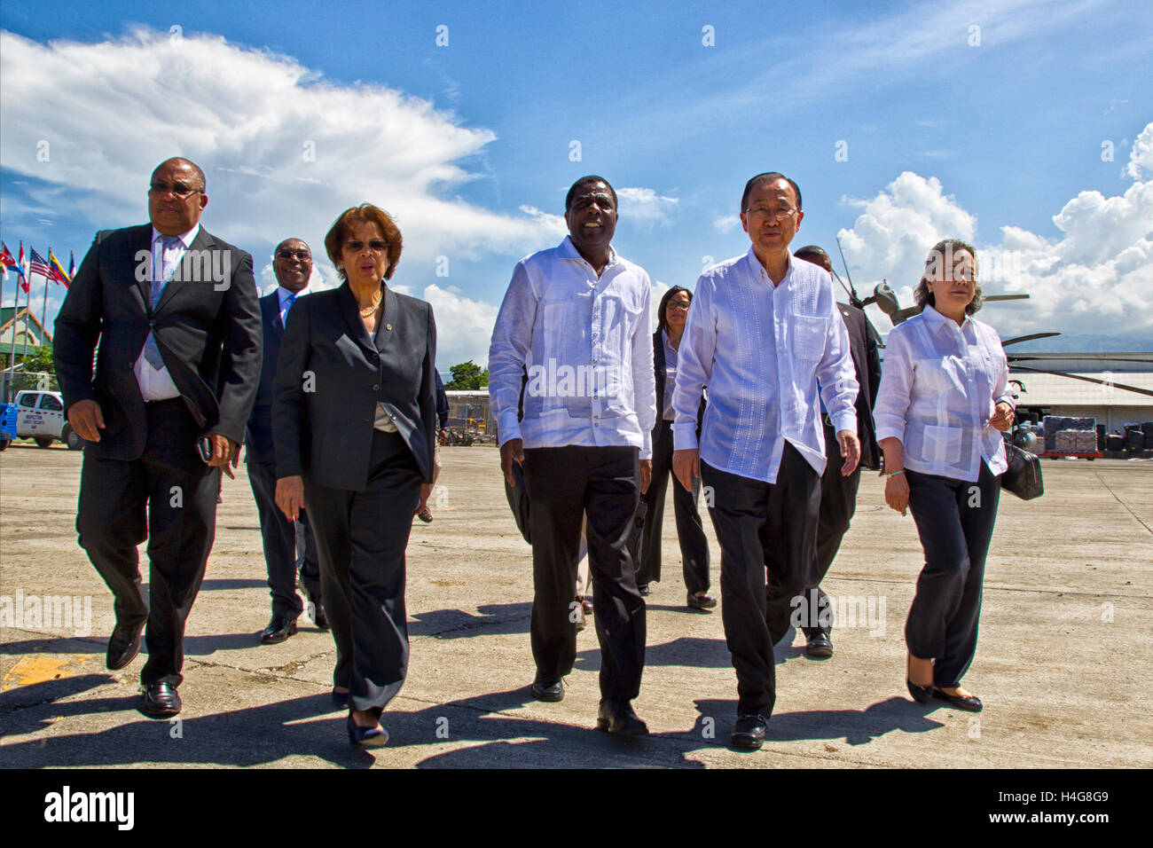 (161015) -- PORT AU PRINCE, Oct. 15, 2016 (Xinhua) -- Image provided by the United Nations Stabilization Mission in Haiti (MINUSTAH) shows UN Secretary-General Ban Ki-moon (2nd R) arriving at the Port-au-Prince International Airport, accompanied by Haitian Prime Minister Enex Jean-Charles (C) and UN secretary-general's special representative in Haiti and head of MINUSTAH Sandra Honore (2nd L), in Port-au-Prince, Haiti, on Oct. 15, 2016. Ban arrived on Saturday in Haiti to make a tour to the areas hardest hit by Hurricane Matthew and met with government officials and humanitarian organizations Stock Photo