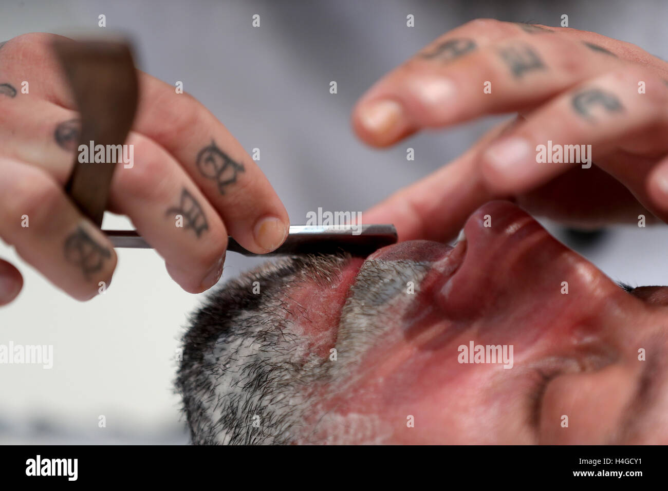 Nuremberg, Germany. 16th Oct, 2016. Windar Abbas, participant at the German Barber Awards 2016, works on a Businesslook Cut and Shave on a model in Nuremberg, Germany, 16 October 2016. PHOTO: DANIEL KARMANN/dpa/Alamy Live News Stock Photo