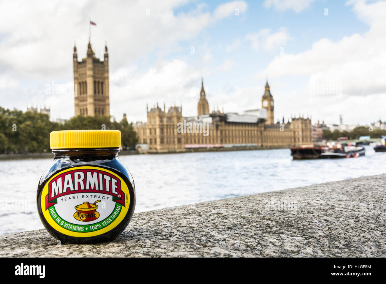 Love it or hate it - a marmite jar on the banks of the River Thames overlooking the Houses of Parliament, London, England, UK Stock Photo