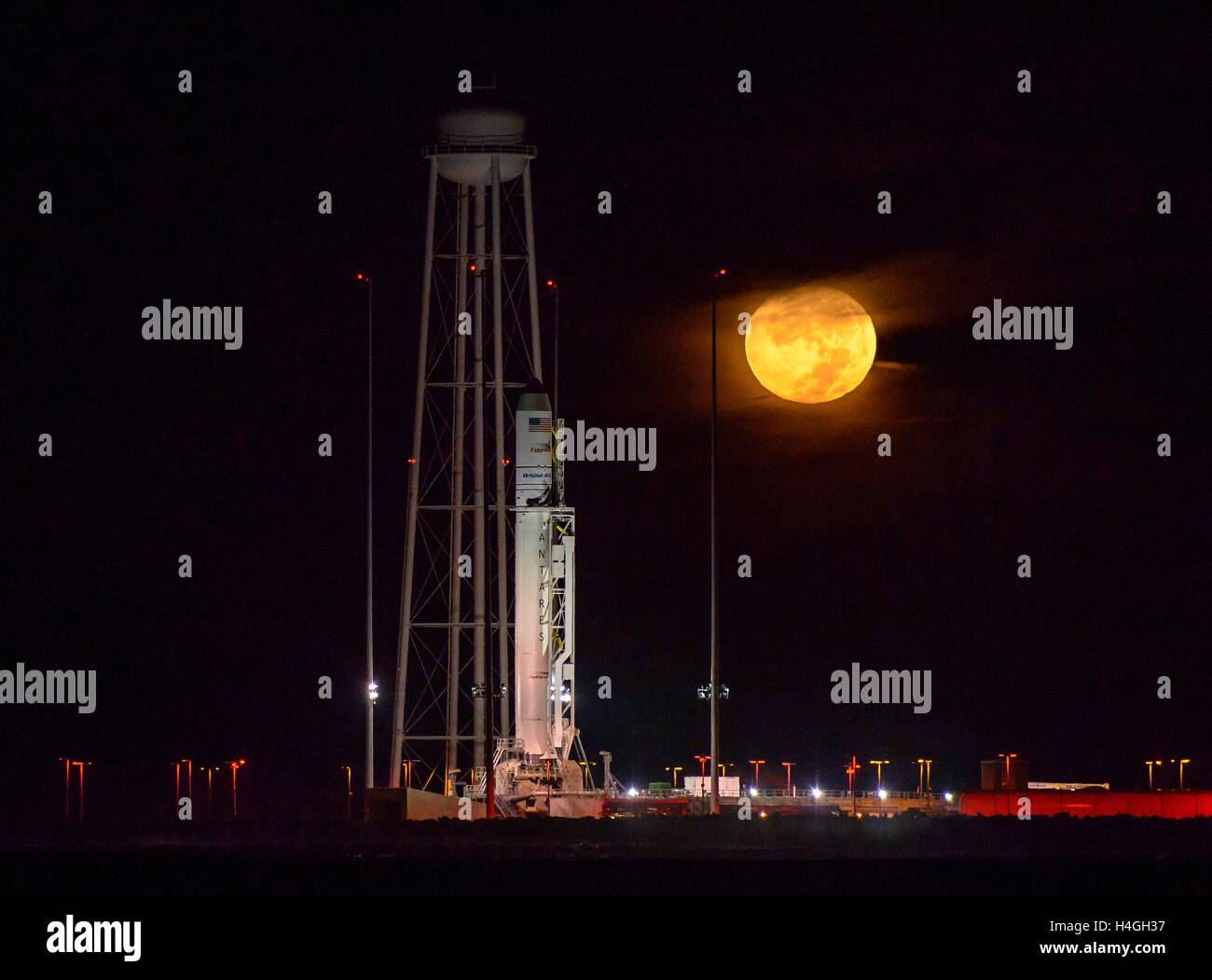 Wallops, Virginia, USA. 15th Oct, 2016. The Orbital ATK Antares rocket with the Cygnus spacecraft onboard, is in ready position at launch Pad-0A, during a full moon at NASA Wallops Flight Facility October 15, 2016 in Wallops, Virginia. The Antares will launch with the Cygnus spacecraft filled with over 5,100 pounds of supplies for the International Space Station. Credit:  Planetpix/Alamy Live News Stock Photo