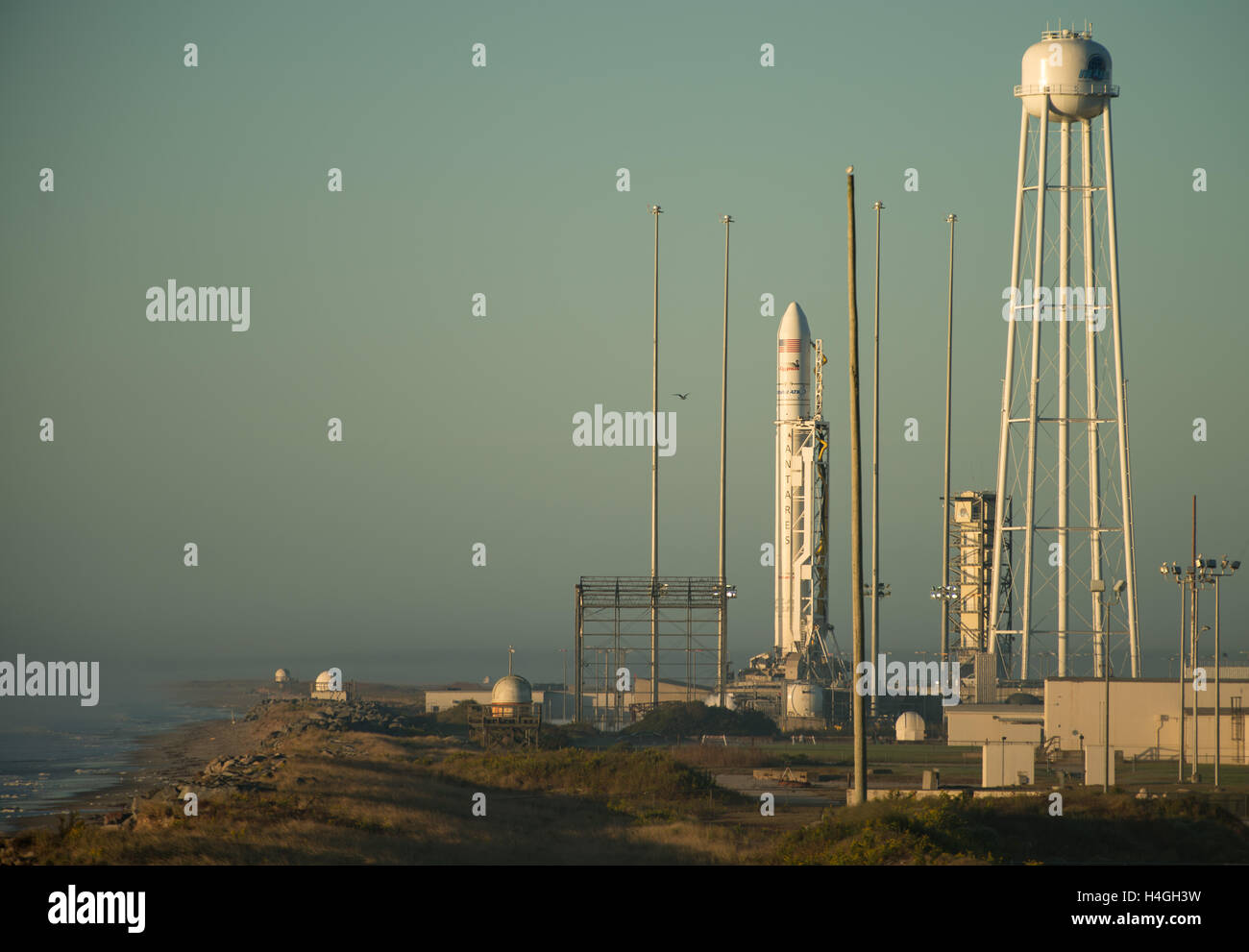 Wallops, Virginia, USA. 15th Oct, 2016. The Orbital ATK Antares rocket with the Cygnus spacecraft onboard, is in ready position at launch Pad-0A, at sunrise at NASA Wallops Flight Facility October 16, 2016 in Wallops, Virginia. The Antares will launch with the Cygnus spacecraft filled with over 5,100 pounds of supplies for the International Space Station. Credit:  Planetpix/Alamy Live News Stock Photo