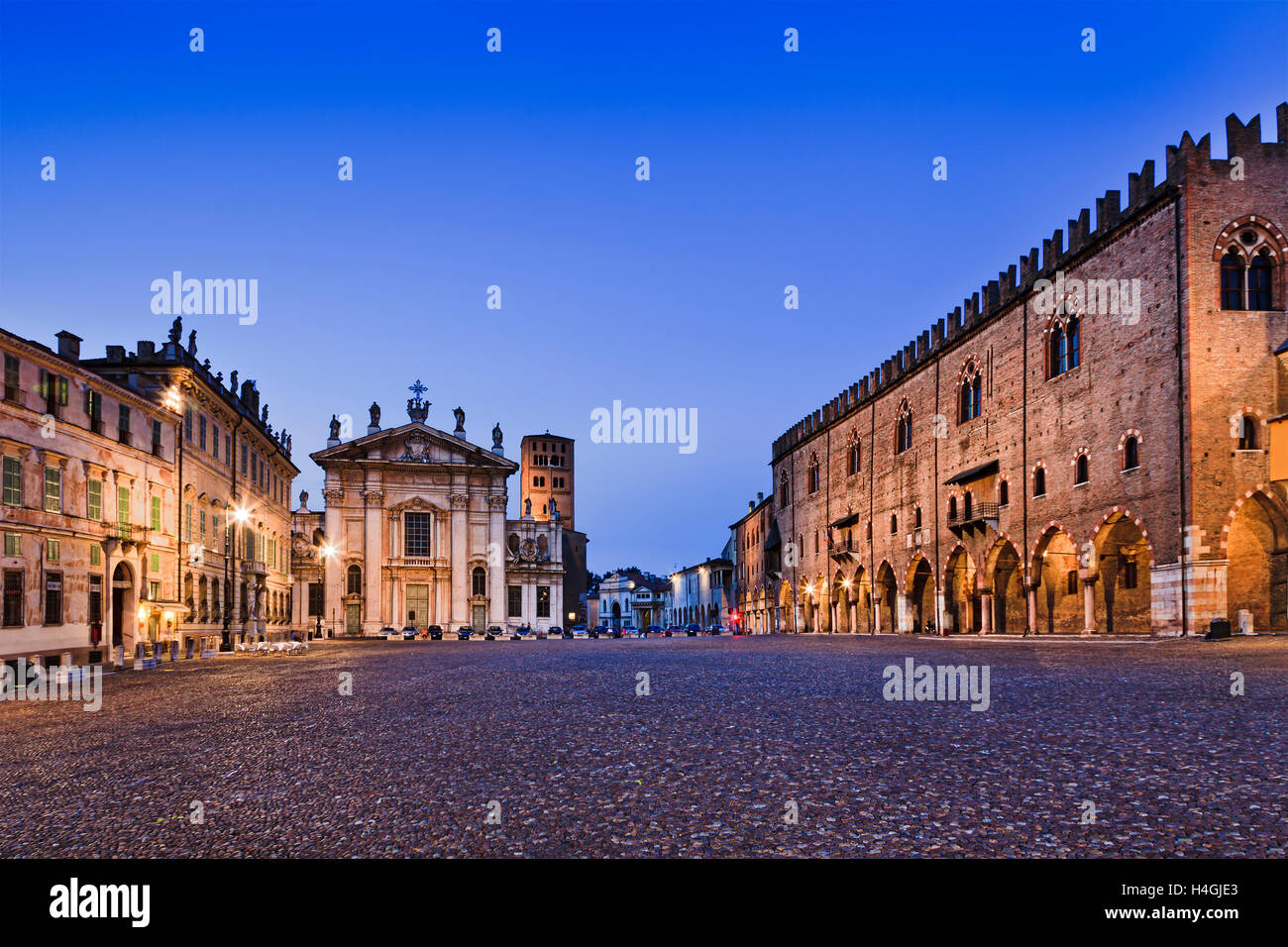 Sordello square at sunset in Mantova's downtown illuminated and empty. Historic landmarks from palaces to churches and castle to Stock Photo