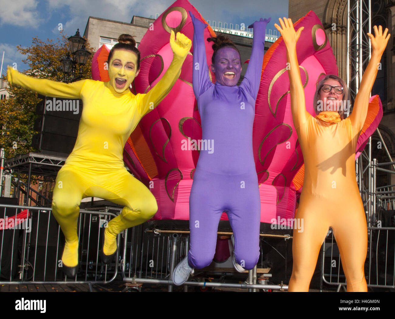 Three Agency actors leaping in Morphsuits at Indian festival in Manchester, UK Stock Photo