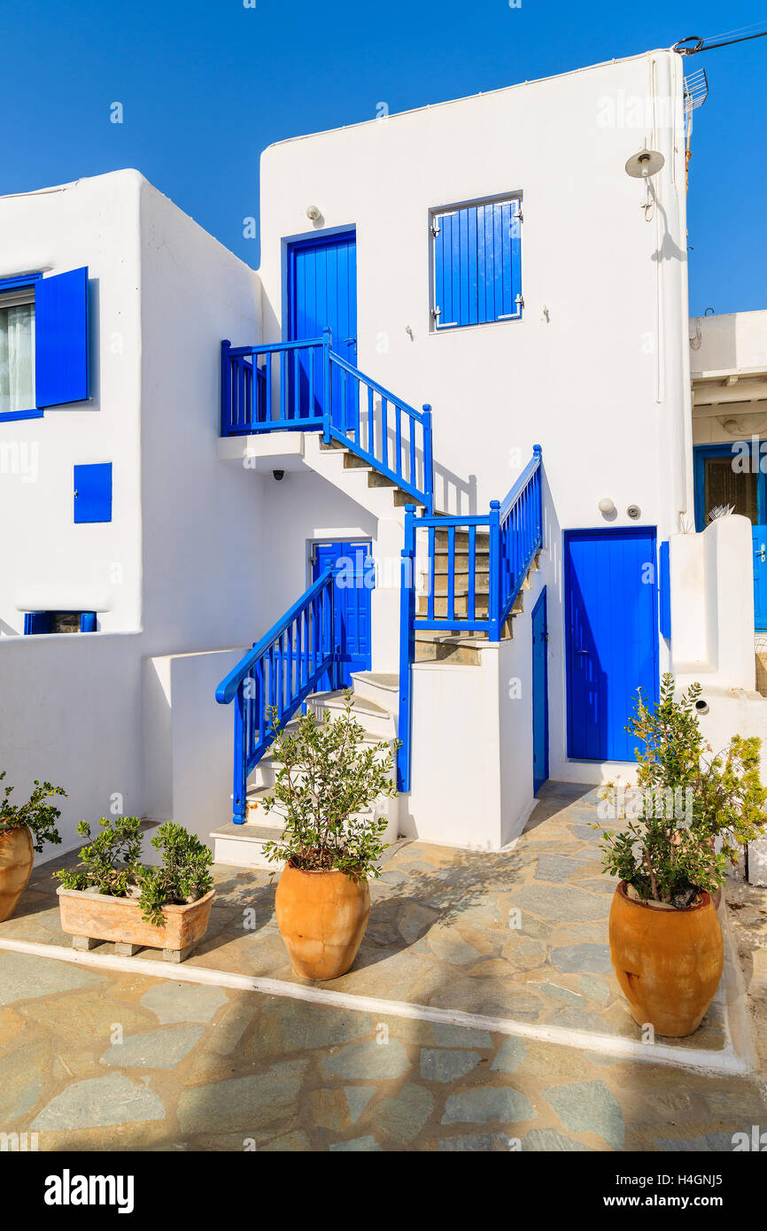 Typical white Greek house with blue doors and windows on island of