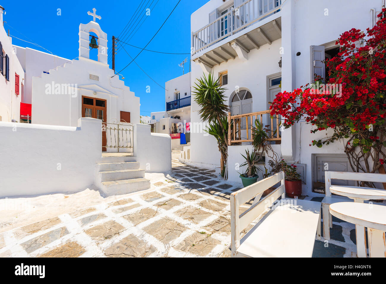 Square with church on whitewashed street with typical Greek architecture in beautiful Mykonos town, Cyclades islands, Greece Stock Photo