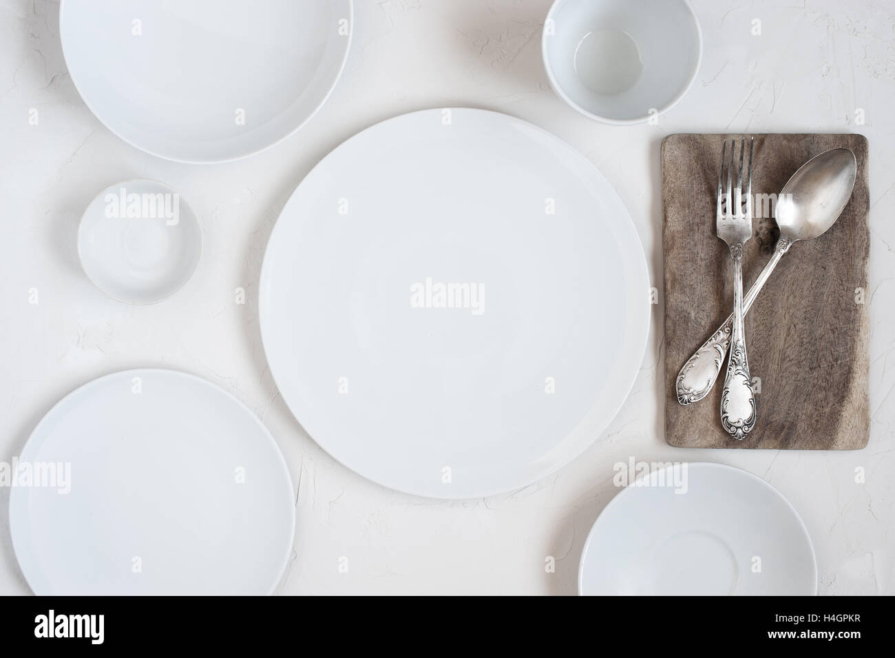 The table with empty white plates Stock Photo - Alamy