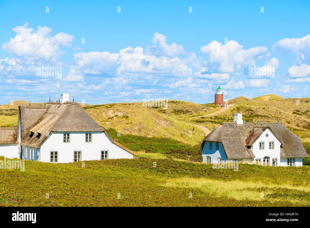 Typical Frisian houses with straw roofs on sand dunes in Kampen village, Sylt island, Germany Stock Photo