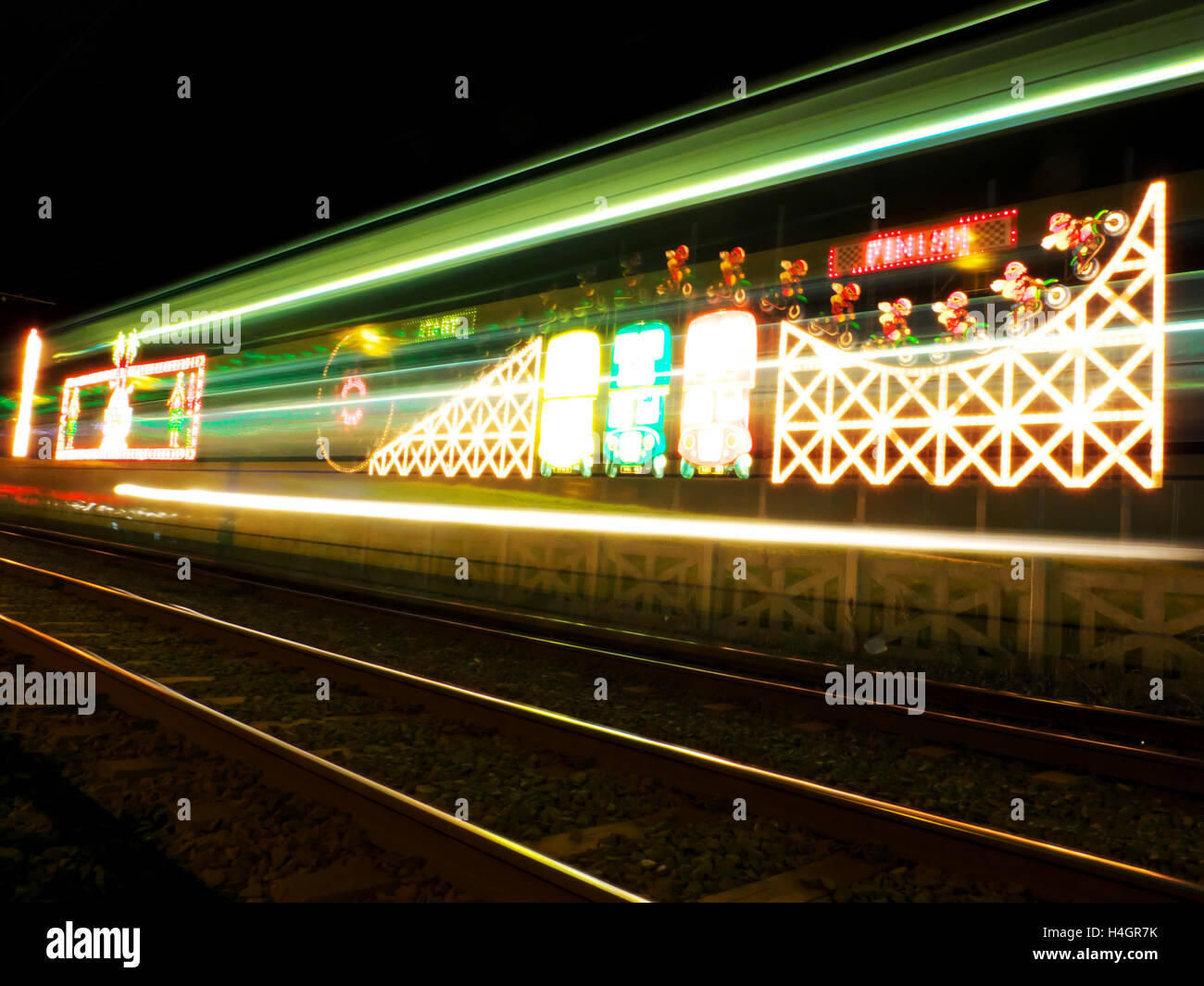 blur of a modern blackpool metro as it travels past the illuminations along blackpool seafront Stock Photo