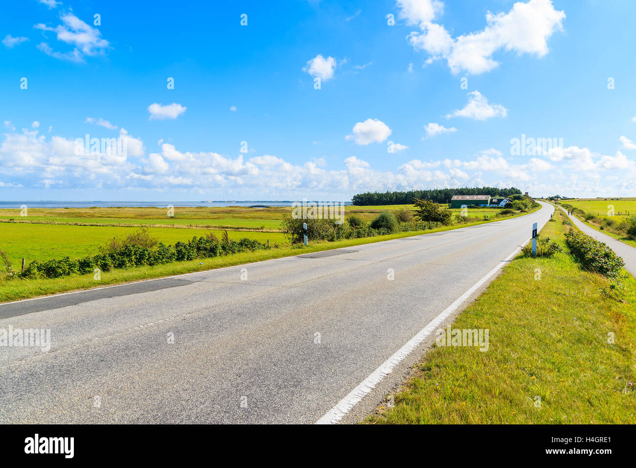 Road along green fields to Keitum village  on Sylt island, Germany Stock Photo