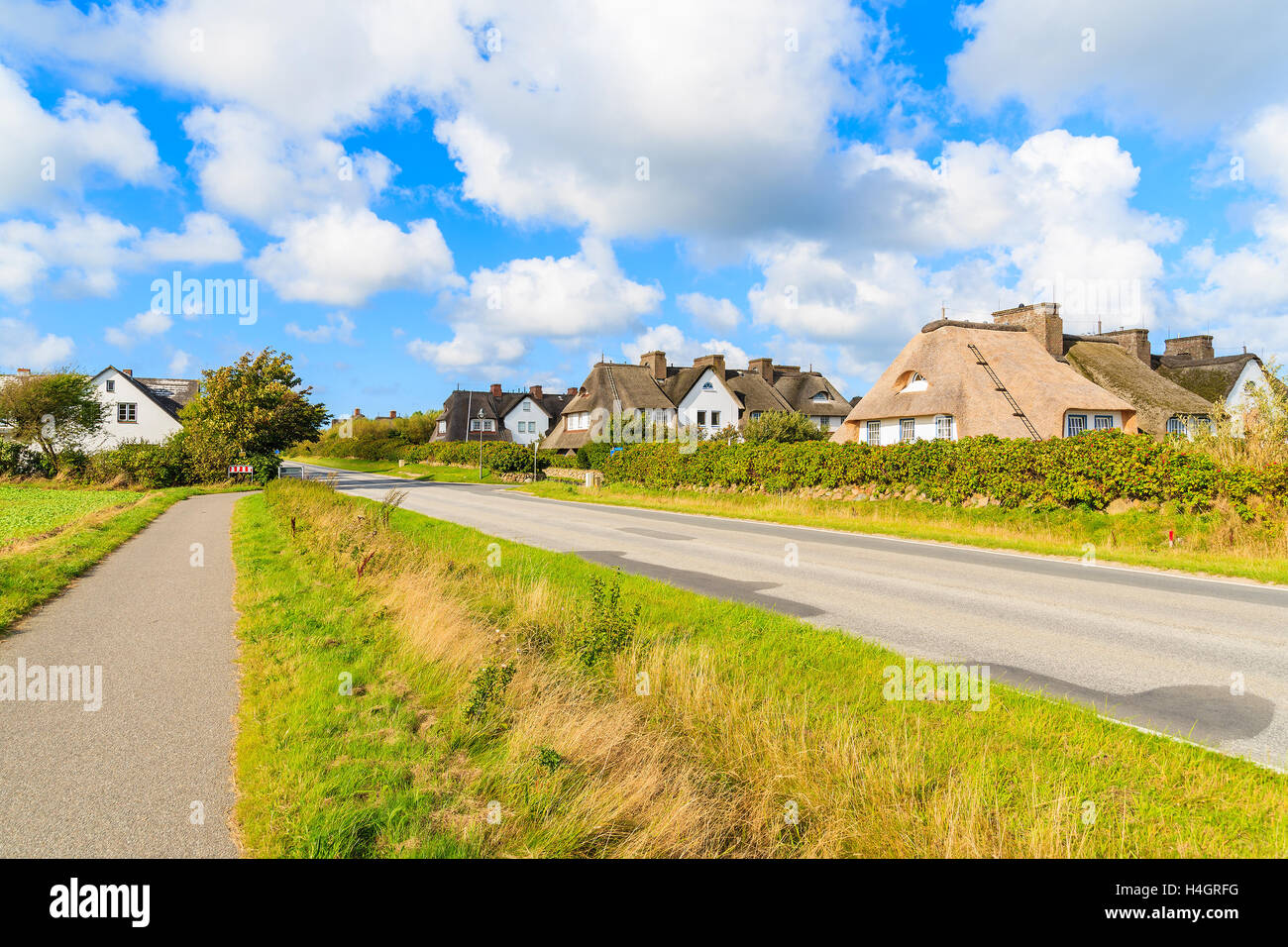 Road in Keitum village with typical straw roof houses on Sylt island, Germany Stock Photo