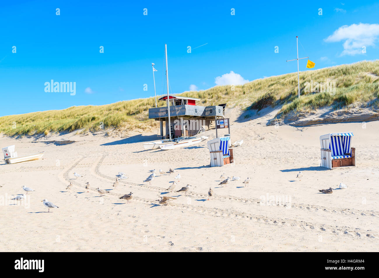 SYLT ISLAND, GERMANY - SEP 11, 2016: seagull birds and lifeguard tower on sandy Kampen beach, Sylt island, Germany. Stock Photo