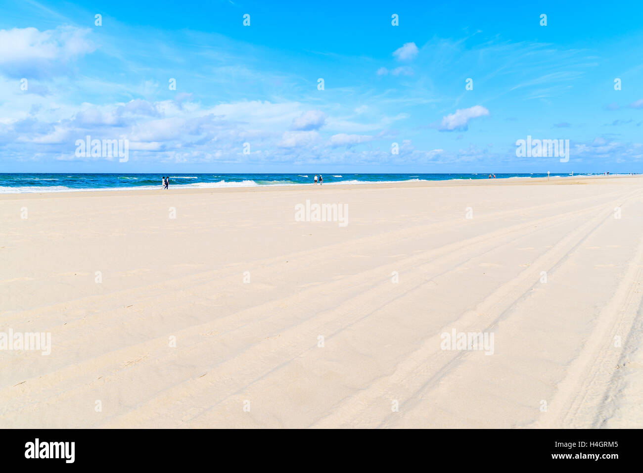 Beautiful white sand beach with people walking along sea in background, Sylt island, Germany Stock Photo
