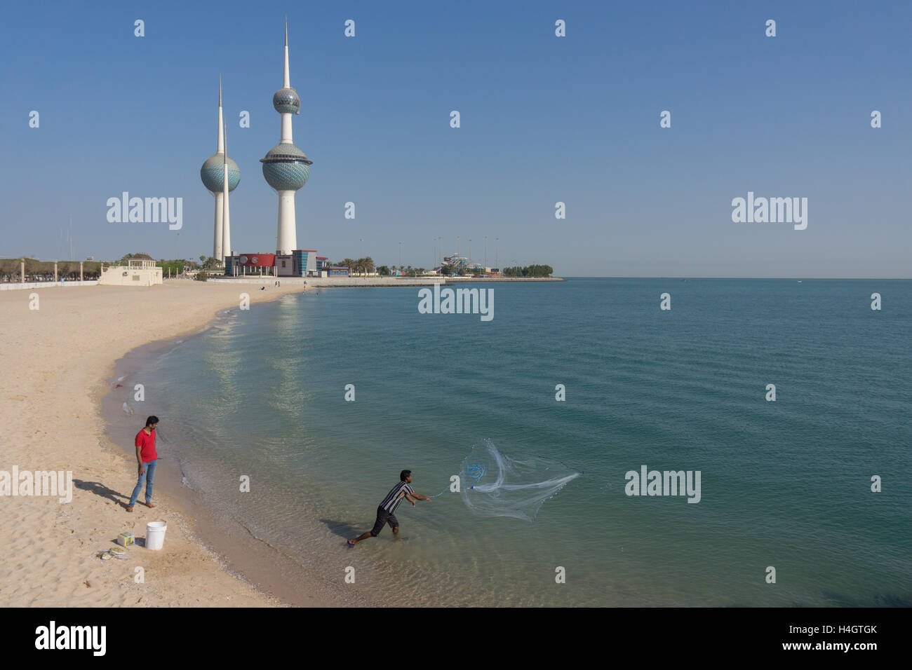 Fisherman fishing in front of the Kuwait towers Stock Photo Alamy