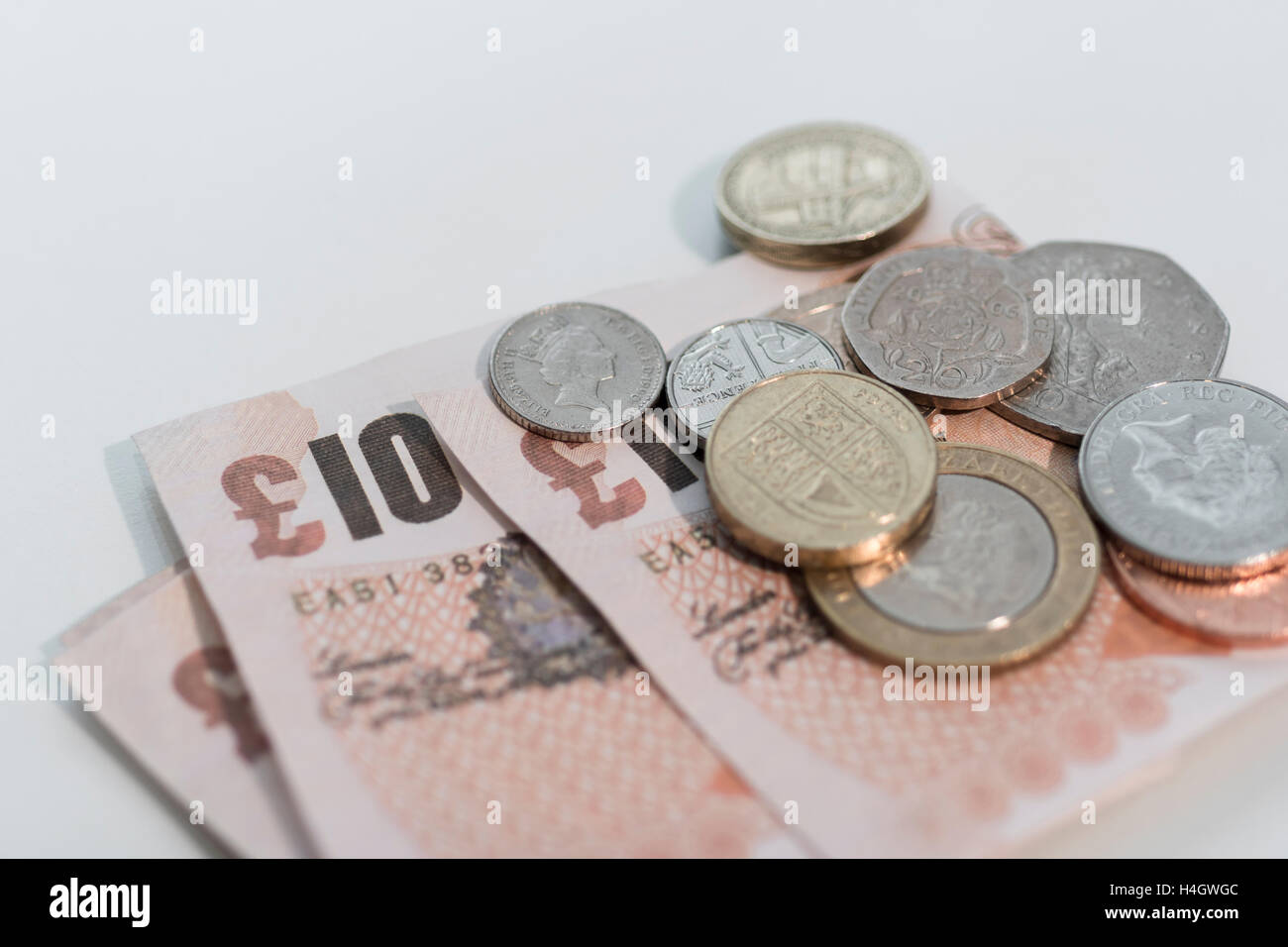 Picture of UK £10 notes and loose change - metaphor for concept of cost of living, wages and pay, spending power, and savings. Stock Photo