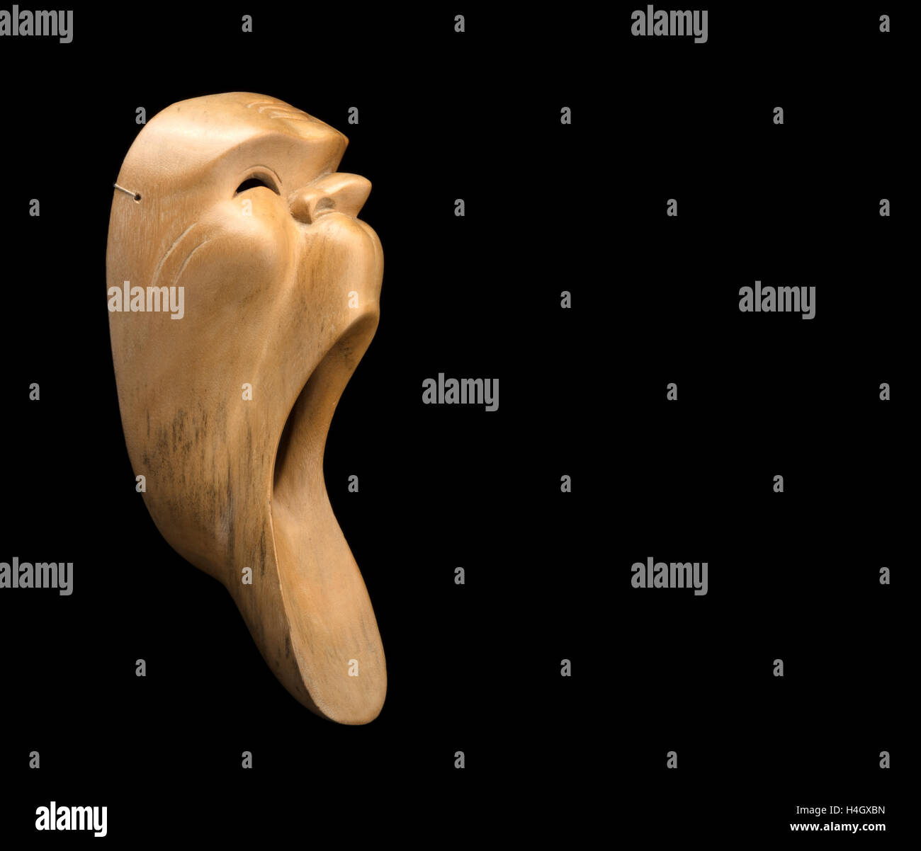 wooden Asian mask screaming. free space for text Stock Photo