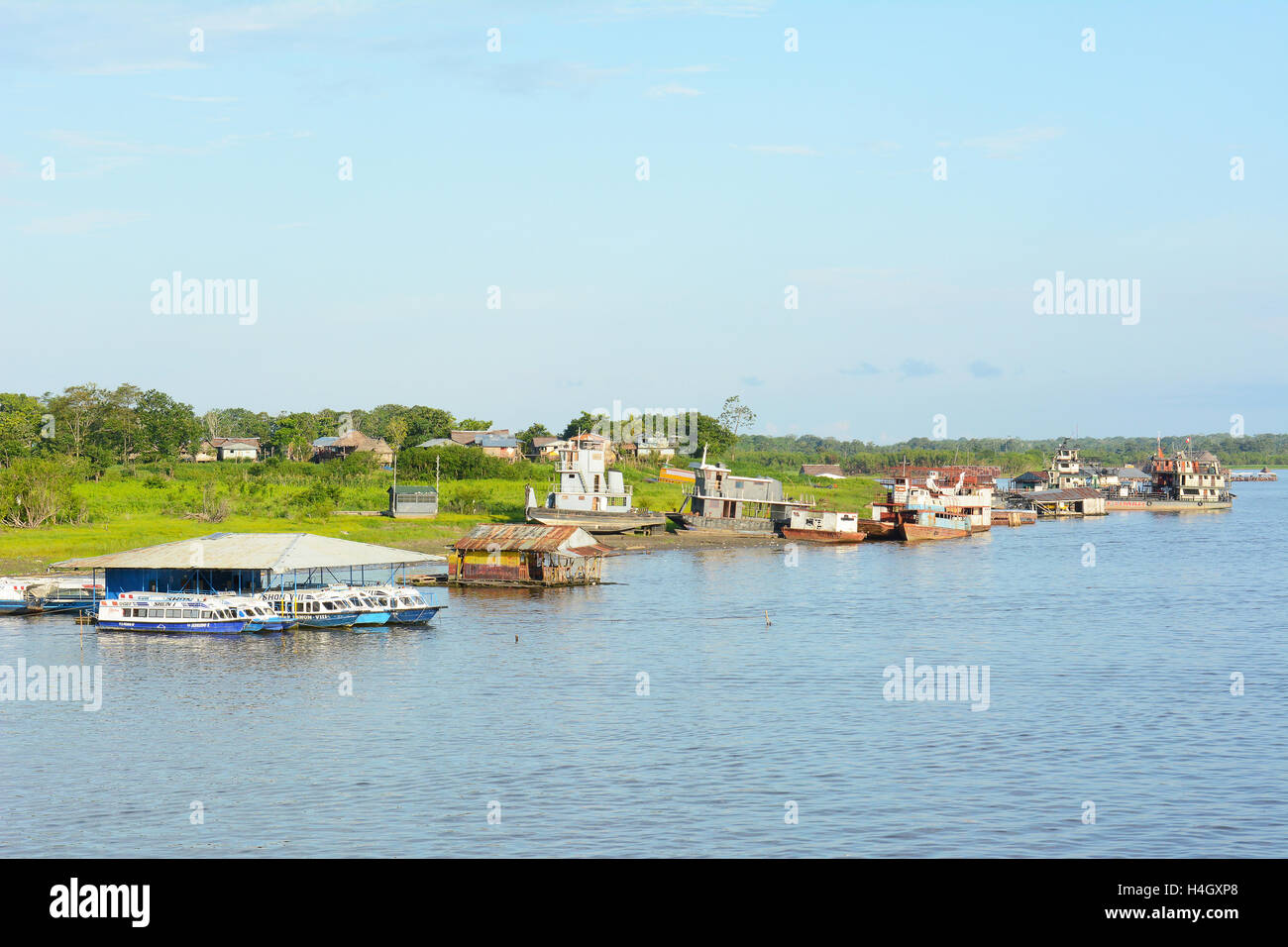 IQUITOS, PERU - OCTOBER 16, 2015: Boats at dock in the Itaya River. Iquitos is the largest metropolis in the Peruvian Amazon, an Stock Photo