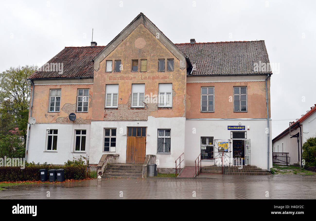 An old building in Lankiejmy, Masuria, Poland, now housing a shop was, in German times, a hotel. Stock Photo