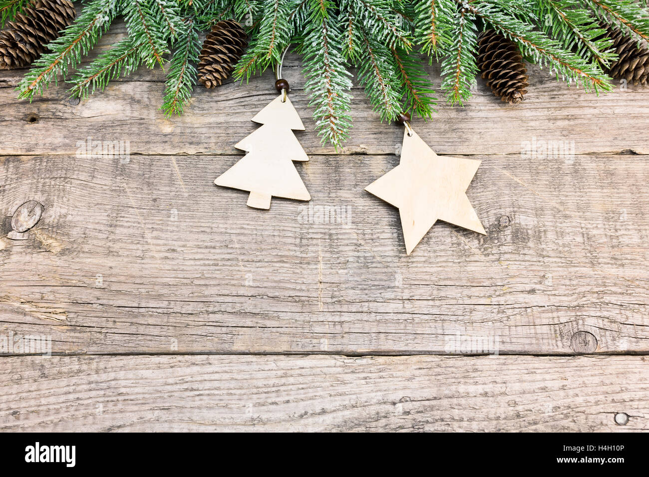 christmas fir tree border with pine cones on rustic wooden board Stock ...