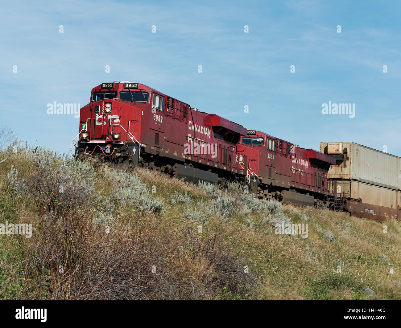 Canadian Pacific Railway locomotives pulling intermodal rail cars on a freight train, Alberta, Canada Stock Photo