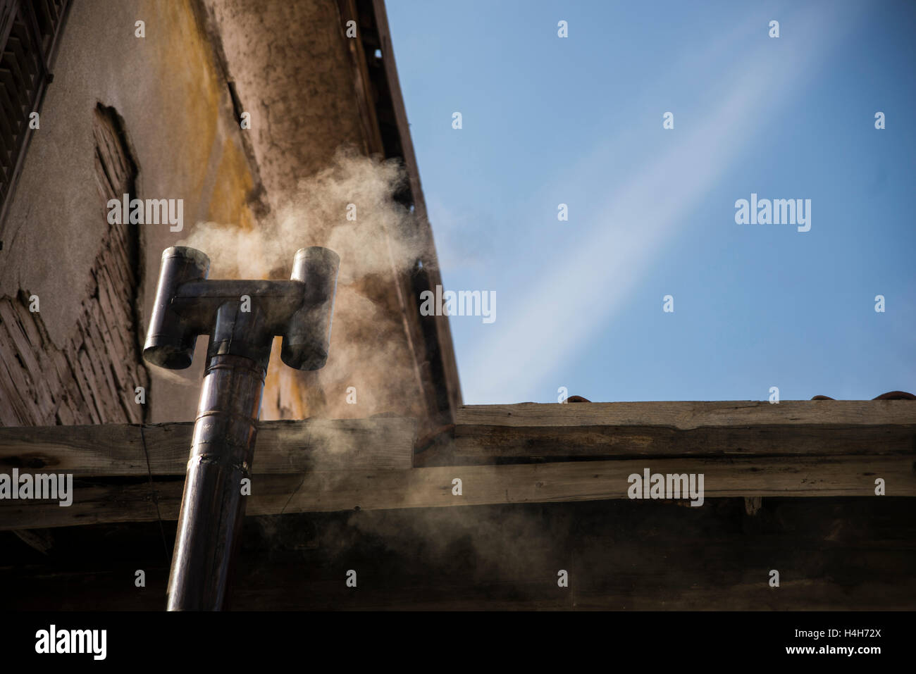 Old stove is smoking from the flue Stock Photo Alamy
