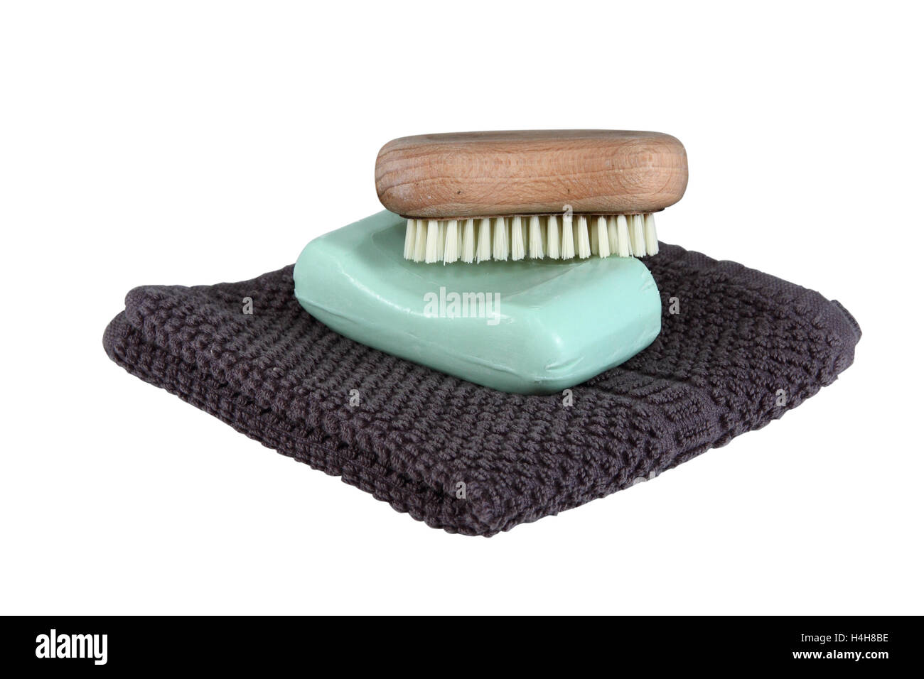 A simple mans face wash collection isolated over white.  Includes face cloth, bar of soap, and a scrub brush. Stock Photo