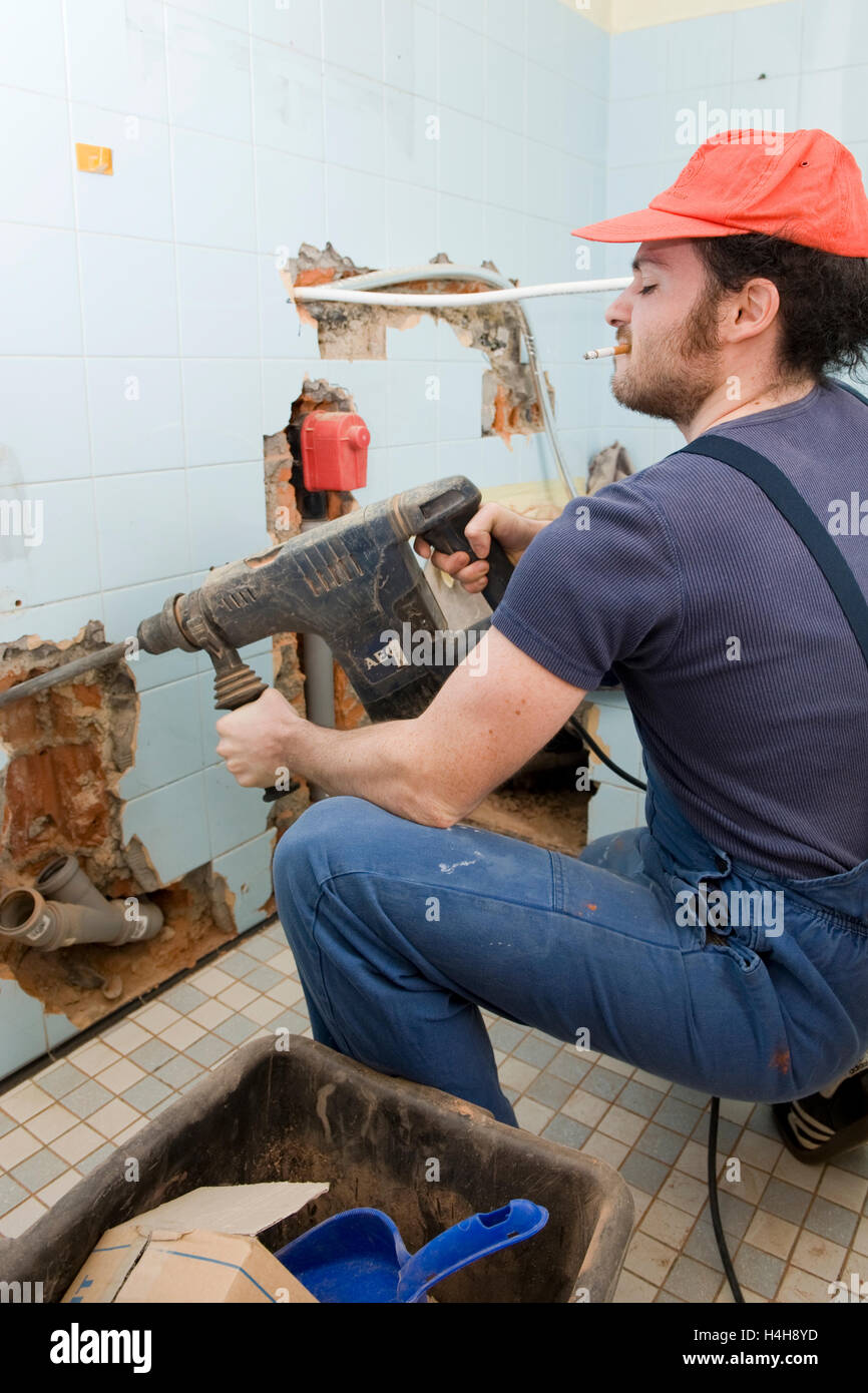 Smoking craftsman working with a drill Stock Photo Alamy